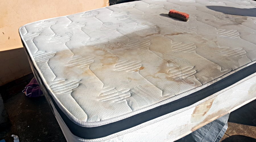 dirty mattress being cleaned